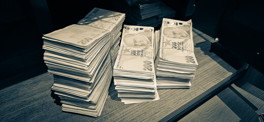 Bales of Turkish Lira banknotes in the bank in front of the cash register