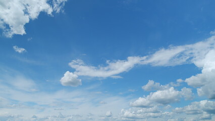 Flying moving white clouds in a blue sky. Blue sky background with many layers tiny clouds....