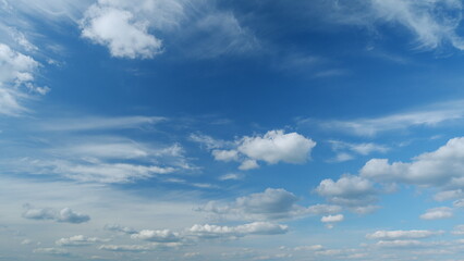 Fluffy layered clouds sky atmosphere. Majestic amazing blue sky with clouds. White and blue colors. Timelapse.