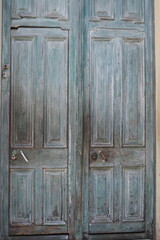 A large light blue door as an entrance to the building.
