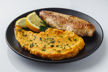 delicious mashed sweet potatoes and fried chicken breast on a white background