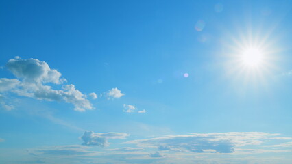 Beautiful blue sky with sunbeams and clouds. Clouds at blue sky background. Sunny cloudscape. Time...