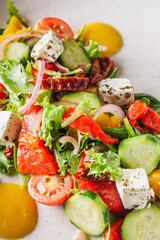 salad with baked bell peppers tomatoes cucumber red onion and feta cheese
