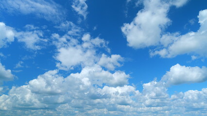 Puffy fluffy white cloud. Summer blue sky background. Time lapse.