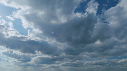 White stratocumulus and stratus cloudscape on beautiful sunny clear sky. Tropical summer sunlight....