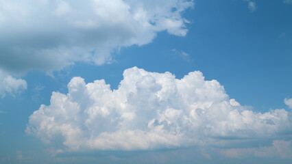 White cumulonimbus fluffy clouds blue sky moving background. Moving and changing cloudscape...