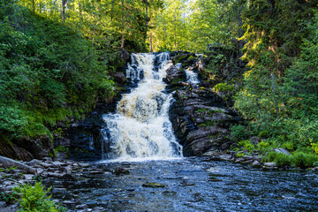 beautiful picturesque strong bubbling waterfall in the ruskeala mountain park in karelia in russia