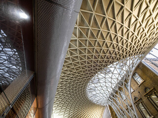 Naklejka premium London, United Kingdom - February 26, 2024: Kings Cross railway station in London. The modern metal structure merges with the old architecture