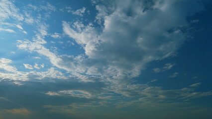 Sun rays and clouds in blue sky. atural sky backdrop weather conditions. Beautiful blue sky with...