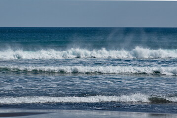 Fototapeta premium Russia. The Far East. The Kuril Islands. Storm waves coming towards the gusty wind from the shore of Iturup Island in the Sea of Okhotsk.
