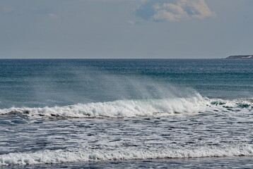 Russia. The Far East. The Kuril Islands. Storm waves coming towards the gusty wind from the shore of Iturup Island in the Sea of Okhotsk.