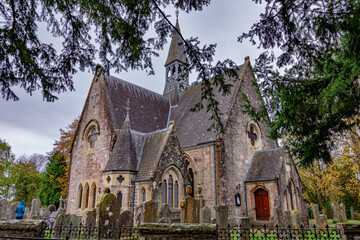 Luss parish Church of Scotland in a colorful cloudy autumn day