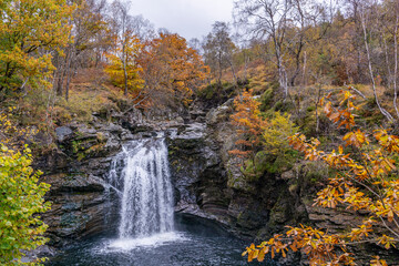 Falls Of Falloch in a colorful autumn gloomy beautiful day