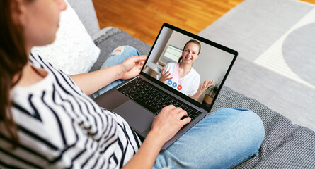 Patient video calls his doctor from home using laptop. Telemedicine, E-health. Medical consultation in the Internet.