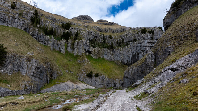 Gordale Scar is a limestone ravine 1 mile (1.6 km) north-east of Malham, North Yorkshire, England.[1] It contains two waterfalls and has overhanging limestone cliffs over 330 feet (100 m) high. T
