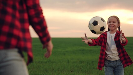 mother playing with child kid soccer field, child playing soccer ball with parent green lawn, happy...