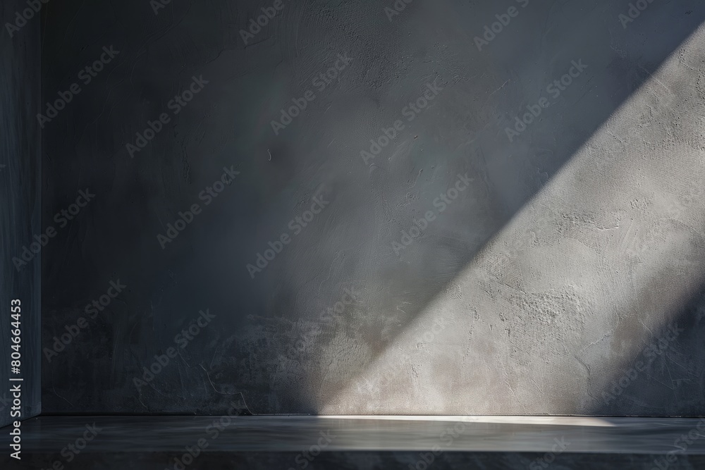 Poster a low-angle view of an empty room with a minimalist gray plaster wall, bathed in soft light emanatin