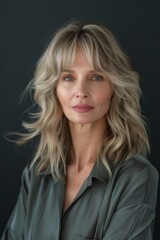 Fototapeta premium a model that is 50 years old with soft side-swept hairstyle with bangs 