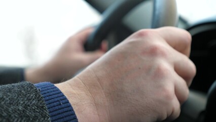 Man driving car transportation hands holding steering wheel closeup. Male arm riding automobile transport enjoy freedom speed drive road trip travel exploration at countryside highway