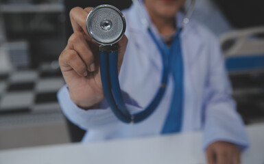 Close-up of female doctor using stethoscope , focus on stethoscope