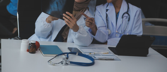 Doctor discussing diagnosis during the meeting. Group of doctor discussing work matter in the...