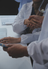 The medical team joins hands and works togetherGroup of scientists joining hands to create...