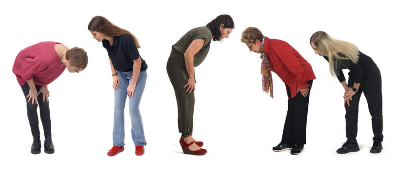 group of woman crouching looking at the ground on white background