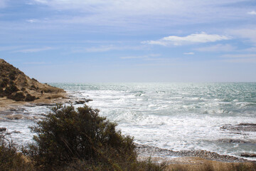 waves crashing on the beach,natural background of sky, sea and rocks, Mediterranean coast in Spain 