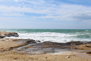 Fototapeta na wymiar natural background of sky, sea and rocks, Mediterranean coast in Spain, waves on the beach