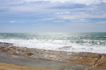 waves on the beach, natural background of sky, sea and rocks, Mediterranean coast in Spain