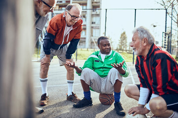 Group of senior men enjoying a conversation and sports in a park