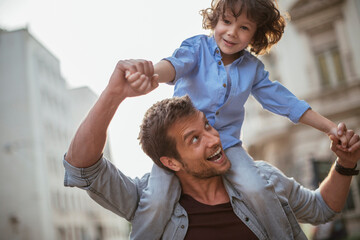 Playful father and son having fun in the city