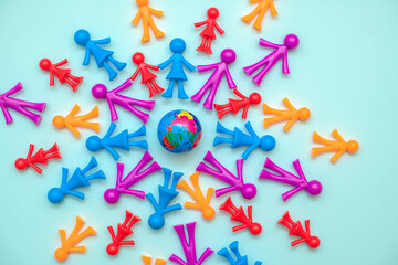 Multicolored plastic people on globe. The use and depletion of the planet earth, overpopulation and...