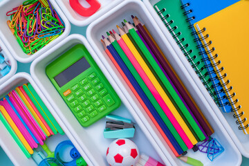 School supplies.Concept back to school. colored stationery is arranged in white organizers. Creative Drawer Organizing. Storage office supplies.