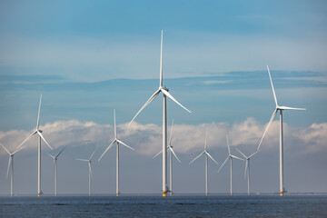 Wind farm of wind mills, generators, wind turbines, off shore in a sea or lake IJsselmeer in the...