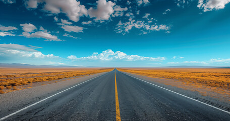 Fototapeta premium the road to the sky, a straight road leading into the distance, clear blue sky with clouds.