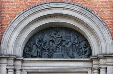 Obraz premium Portal above the entrance to the cathedral in Plock, Poland