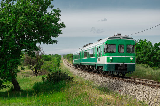 Green train or zeleni vlak, connecting Ljubljana, Slovenia and Pula, Croatia, on its way towards the end station. Picturesque green train in between the istrian scenery and straight track