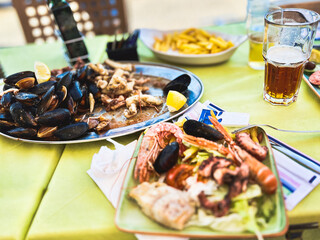 Seafood platter with musselspus, squid, squidpus and French fries a Marsaxlokk cafe, Malta