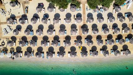 Luxury beach and bamboo umbrellas shot by drone.