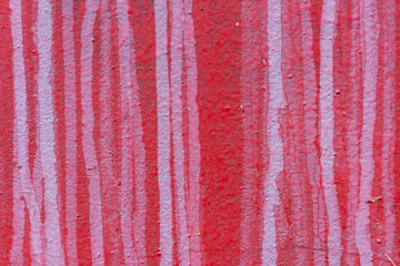 Absctract red coloured wall background. Close-up view of red painted textured concrete wall with white streaks. Copy space for your text or decorations. Colorful construction material background theme
