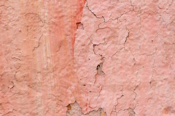 Absctract pink coloured wall background. Close-up view of stained weathered painted textured concrete wall. Copy space for your text or decorations. Colorful construction material background theme.