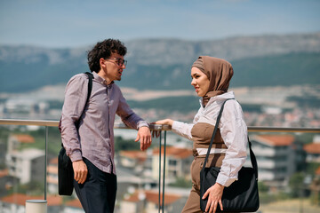 After a day at the office, a business man engages in conversation with his Muslim colleague wearing a hijab