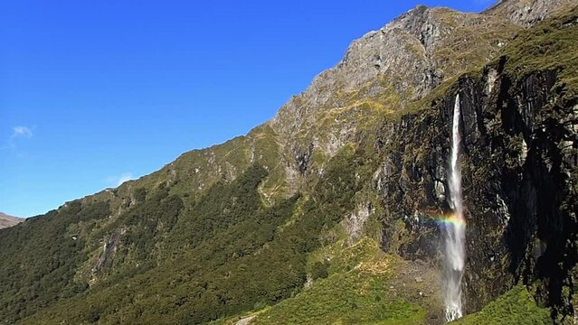 handheld shot of the waterfall and a rainbow near the rob roy glacier in wanaka new SBV 347630373 HD 