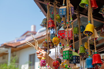 Decorative ornament made with seashells and recycled materials. Tourist souvenir shop. Colorful art and craft. Hand made. Vertical photo. No people, nobody.