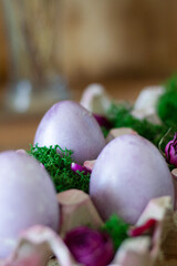 Easter colored eggs in a basket with moss