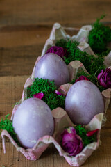 Easter colored eggs in a basket with moss