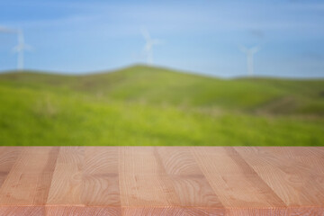 Empty display table with blurred green hills on the background, template for design