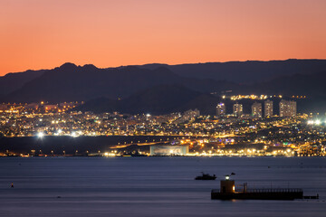Cityscape of illuminated Eilat, Israel against colorful sky