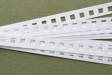 close-up of paper straps from a coil notebook on green paper